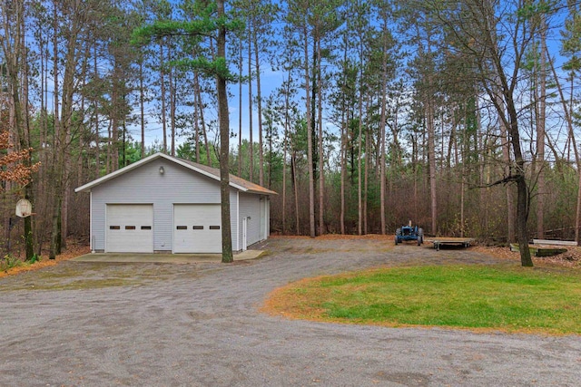 exterior space featuring a garage and an outbuilding