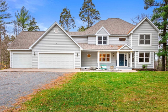 view of front facade featuring a garage, a porch, and a front lawn