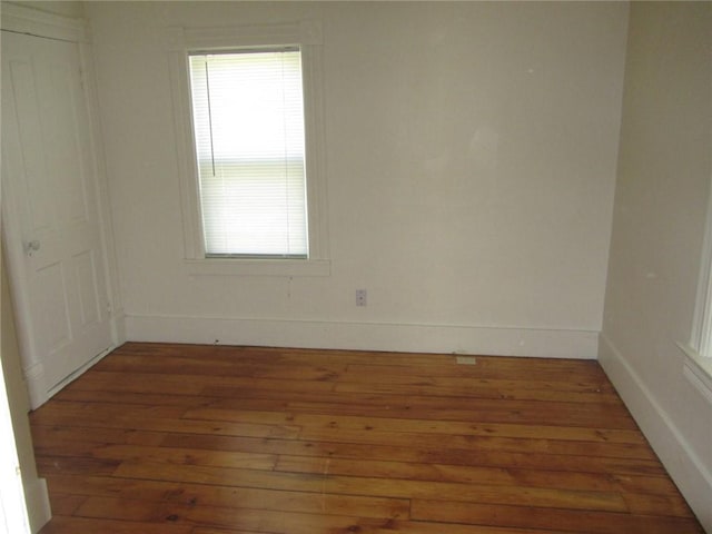 unfurnished room featuring dark hardwood / wood-style flooring