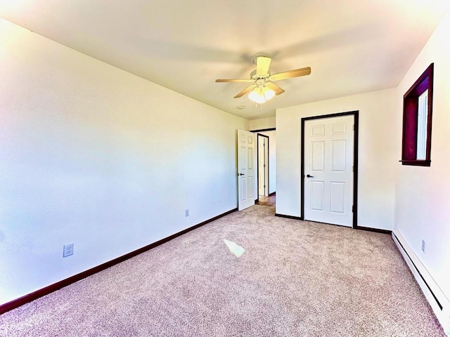 unfurnished bedroom featuring light colored carpet, baseboard heating, and ceiling fan