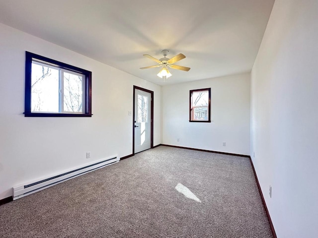 spare room with ceiling fan, a baseboard radiator, carpet flooring, and a healthy amount of sunlight