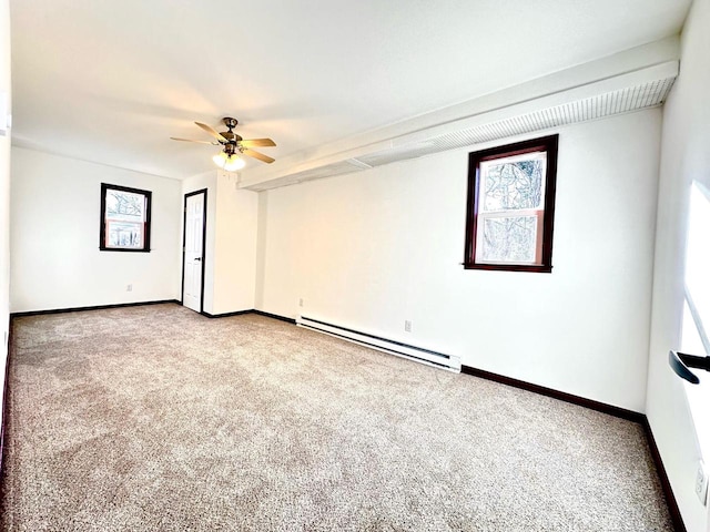 empty room featuring ceiling fan, a baseboard heating unit, and carpet floors