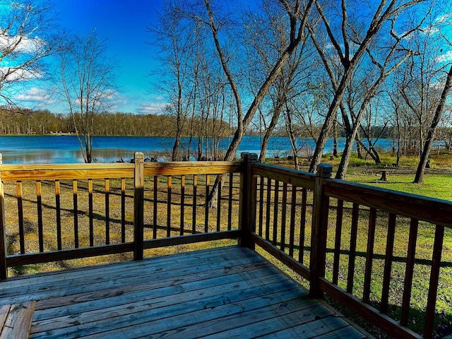 deck featuring a water view and a lawn