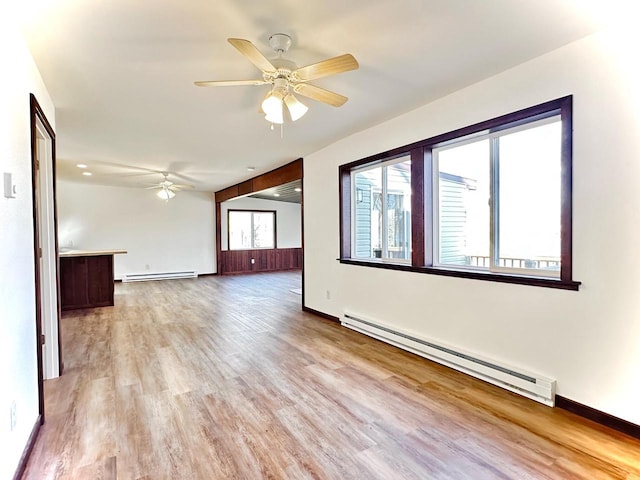 interior space featuring ceiling fan, light hardwood / wood-style floors, and baseboard heating