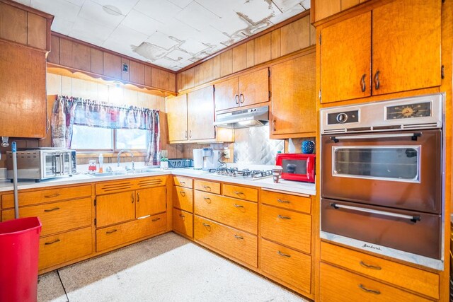 kitchen with white gas stovetop and sink