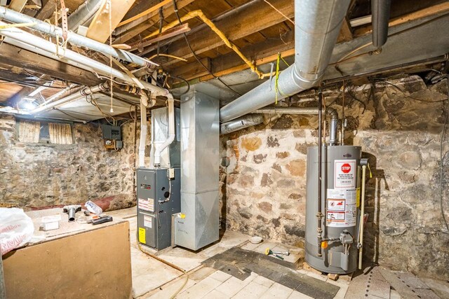 basement featuring heating unit and water heater