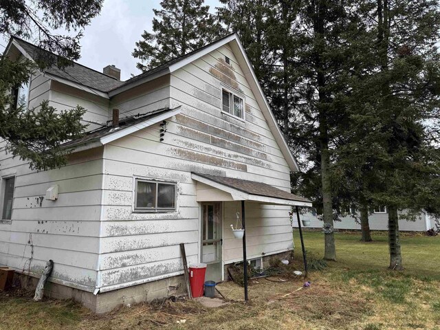 view of side of home with a lawn