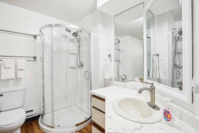 bathroom with hardwood / wood-style floors, vanity, toilet, and an enclosed shower