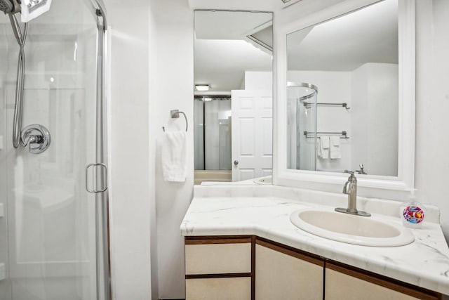 bathroom featuring vanity and an enclosed shower