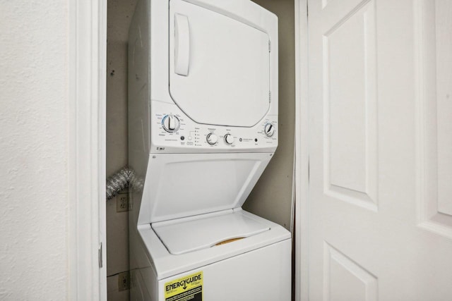 laundry area featuring stacked washer / dryer