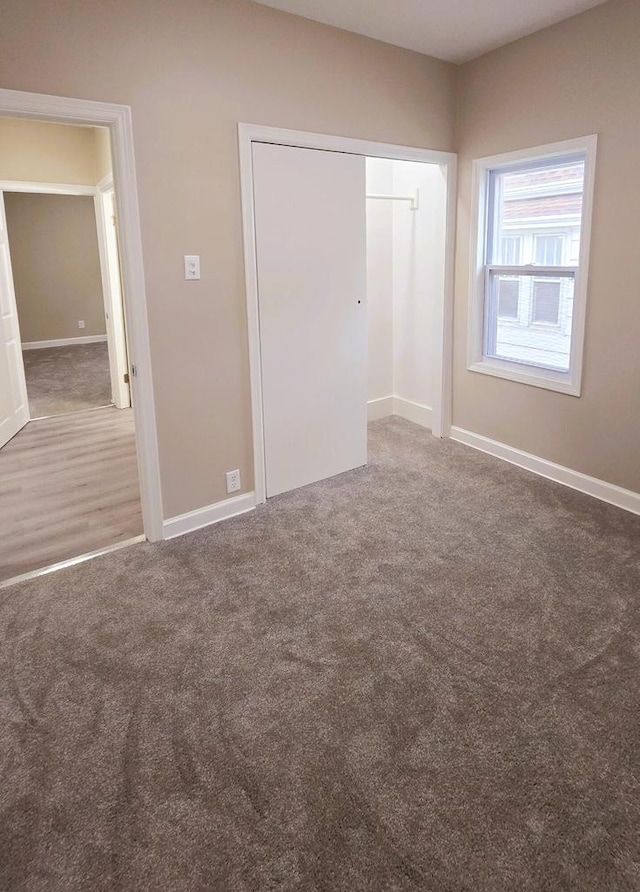 unfurnished bedroom featuring a closet and carpet floors