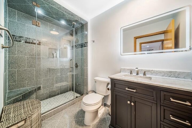 bathroom featuring an enclosed shower, vanity, and toilet