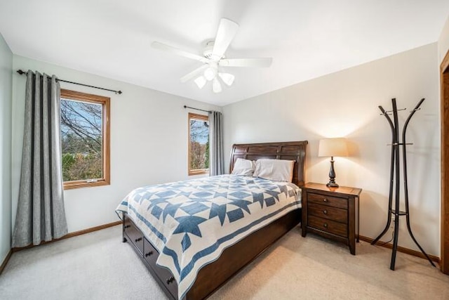 carpeted bedroom with multiple windows and ceiling fan