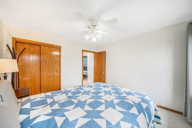 bedroom featuring ceiling fan, a closet, and light colored carpet