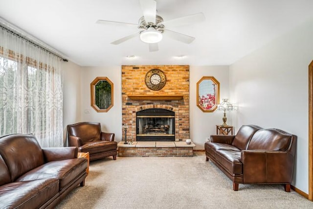 living room with a fireplace, ceiling fan, and carpet