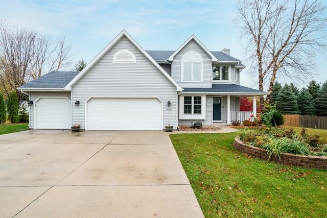 view of front of house featuring a garage, covered porch, and a front yard