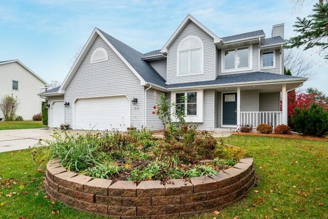 view of front of property featuring a garage, a front yard, and covered porch