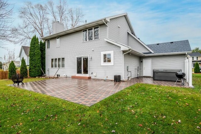 back of property with a patio area and a yard