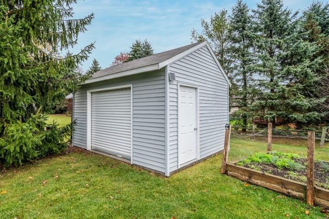 view of outbuilding with a lawn