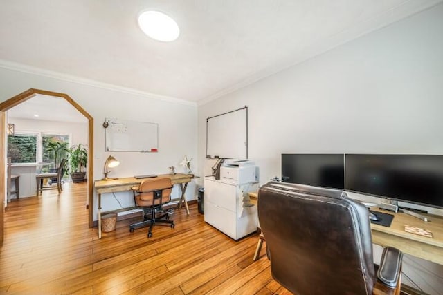 home office featuring ornamental molding and light hardwood / wood-style floors