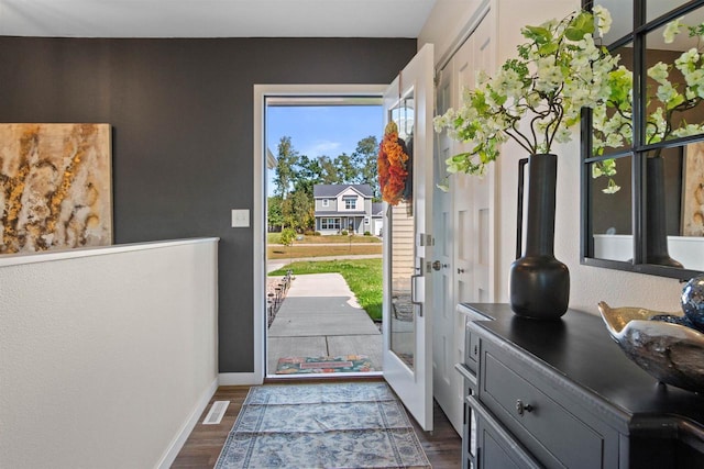 doorway featuring dark wood-type flooring