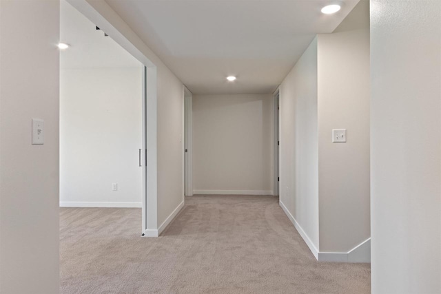 hallway with light colored carpet