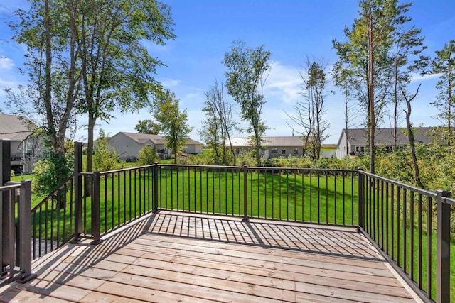 wooden terrace featuring a yard