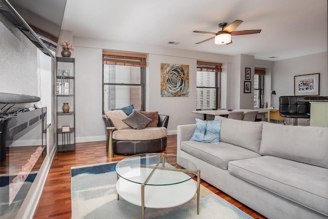 living room with hardwood / wood-style flooring and ceiling fan