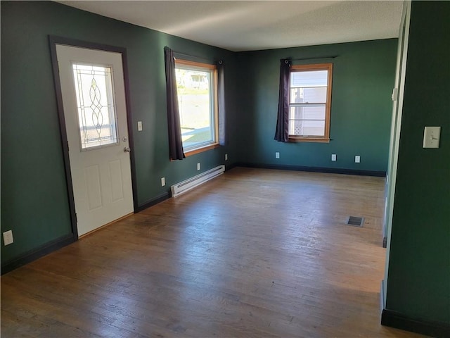 foyer featuring hardwood / wood-style floors and baseboard heating