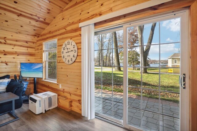 doorway to outside with wood-type flooring, wood ceiling, wooden walls, and lofted ceiling