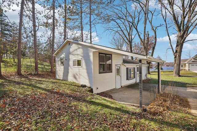 view of home's exterior featuring a patio area and a lawn