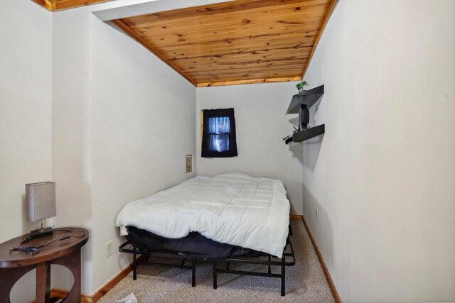 bedroom with light colored carpet, lofted ceiling, and wood ceiling