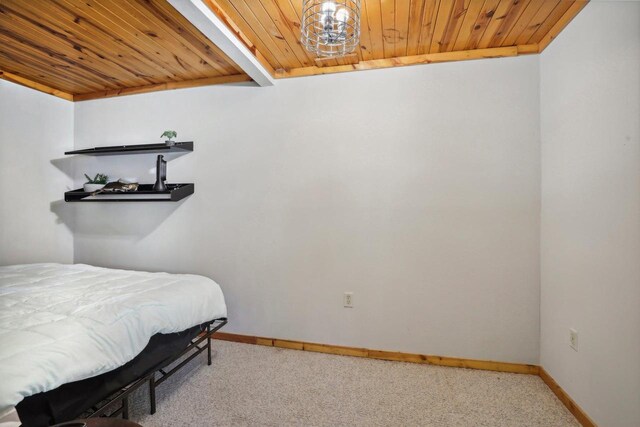 carpeted bedroom featuring wood ceiling