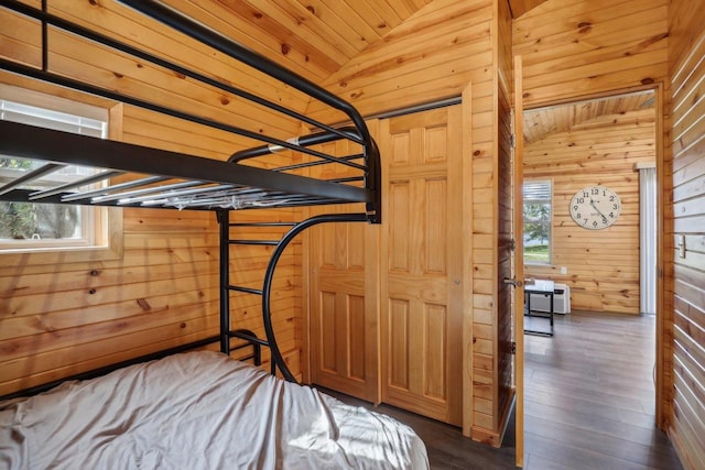 unfurnished bedroom with wood walls, dark hardwood / wood-style floors, wood ceiling, and lofted ceiling