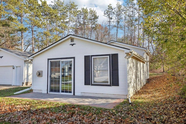 back of house with a garage