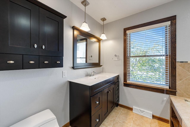 bathroom featuring vanity, tile patterned flooring, and toilet