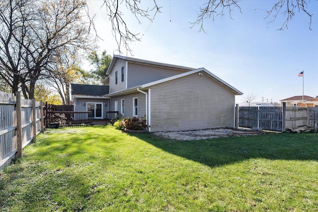 rear view of house featuring a lawn