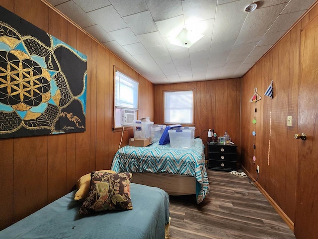 bedroom featuring wooden walls and hardwood / wood-style flooring