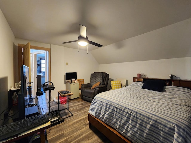 bedroom featuring hardwood / wood-style floors, lofted ceiling, and ceiling fan