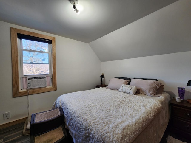 bedroom featuring cooling unit, dark hardwood / wood-style floors, and vaulted ceiling