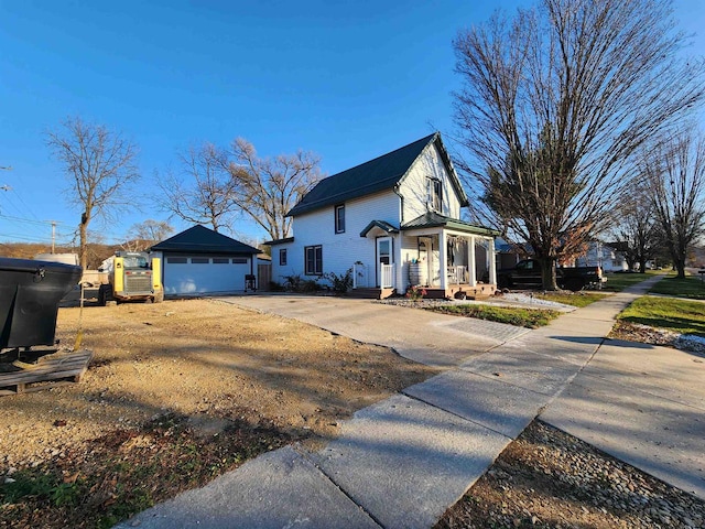 view of side of home featuring an outbuilding and a garage