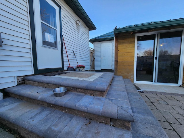 entrance to property featuring a patio area