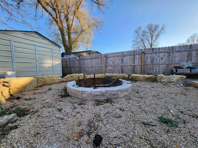 view of yard with an outdoor fire pit