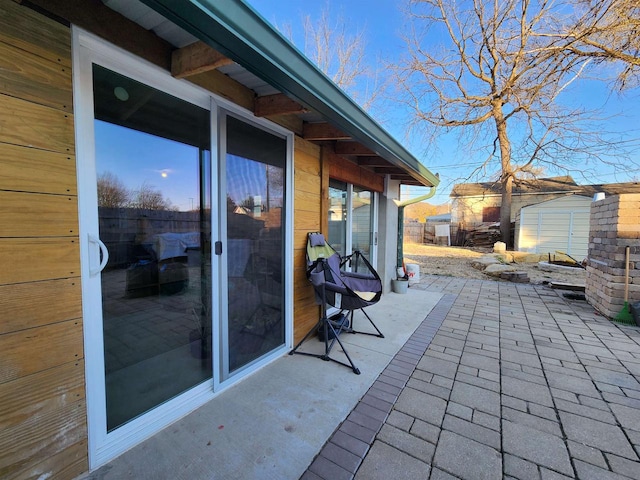 view of patio featuring a storage unit