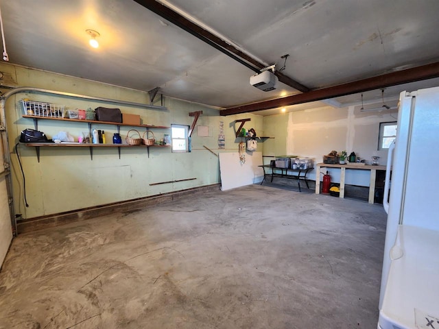 garage featuring a garage door opener and white fridge