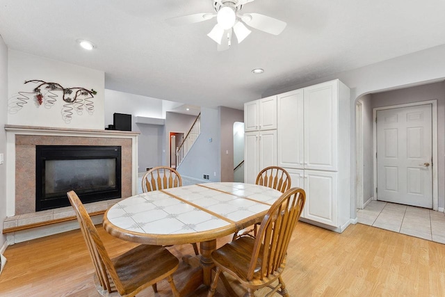 dining space with ceiling fan and light hardwood / wood-style flooring