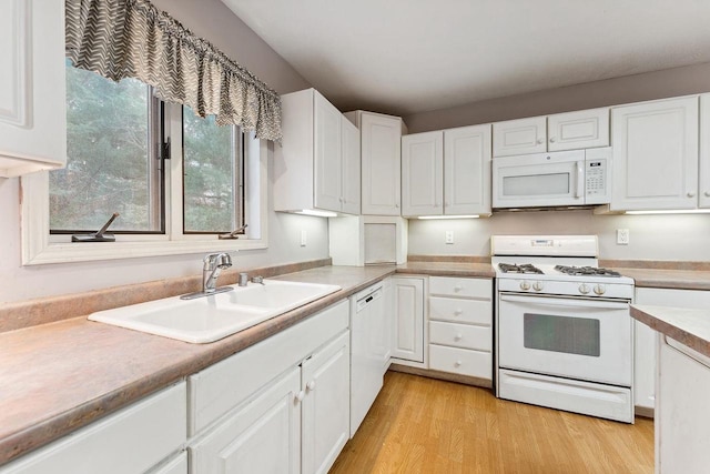 kitchen featuring white cabinets, light hardwood / wood-style flooring, sink, and white appliances