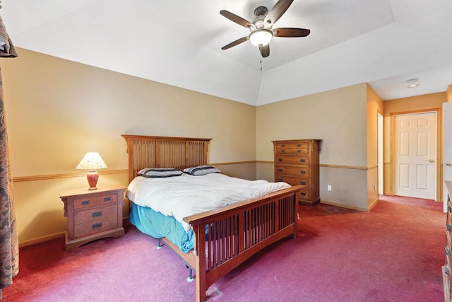 carpeted bedroom with ceiling fan and vaulted ceiling