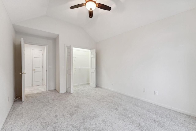 unfurnished bedroom with ceiling fan, light carpet, and lofted ceiling