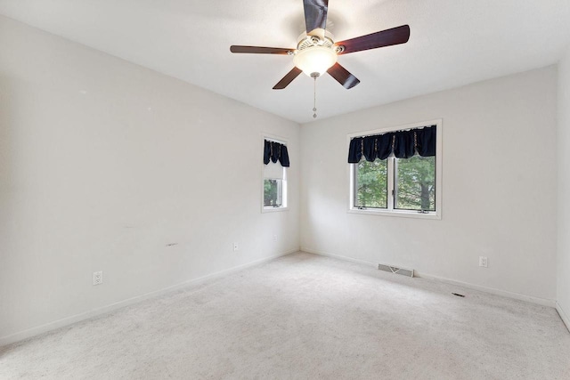 carpeted empty room featuring ceiling fan